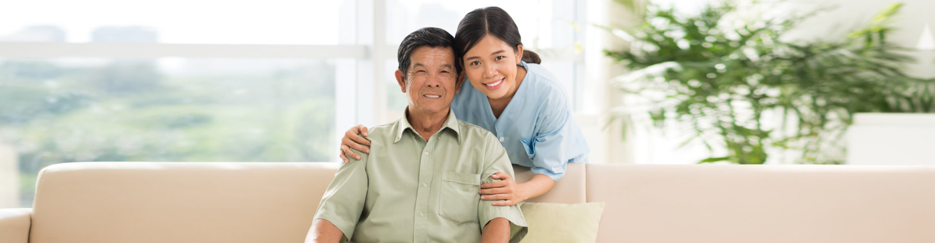 an elderly man with a female caregiver